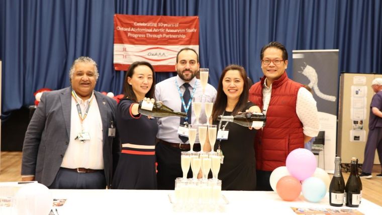 Ashok Handa, Ping Zhan, Pierfrancesco Lapolla-Losasso, Jenny Buisan and Regent Lee standing behind a Champagne tower